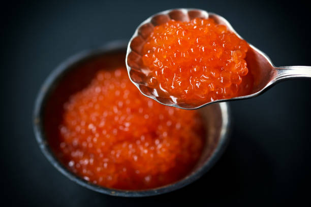 2057830-red-caviar-in-silver-spoon-on-a-dark-background-selective-focus.jpg